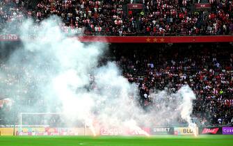 AMSTERDAM - Ajax supporters throw fireworks on the field during the Dutch Eredivisie match between Ajax and Feyenoord at the Johan Cruijff ArenA on September 24, 2023 in Amsterdam, Netherlands. ANP OLAF KRAAK (Photo by ANP via Getty Images)