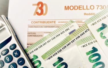 Province of Florence , January 14th 2024, many euro banknotes with the “Modello 730” as background , translating in Italian as declaration of incomes