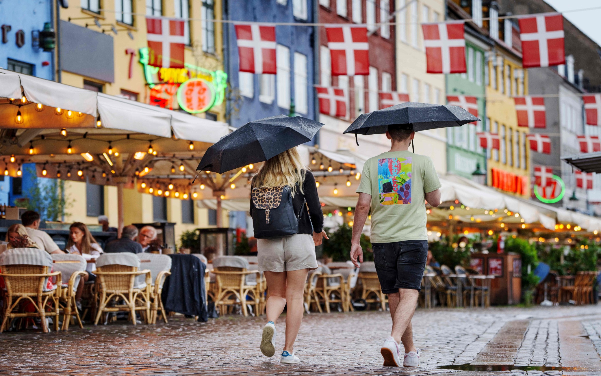 People use umbrellas to shelter from the rain in Copenhagen on June 26, 2023. (Photo by Liselotte Sabroe / Ritzau Scanpix / AFP) / Denmark OUT (Photo by LISELOTTE SABROE/Ritzau Scanpix/AFP via Getty Images)