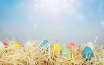 Easter decorations with colored eggs over straw