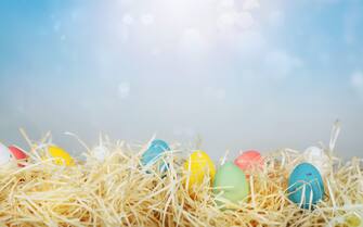 Easter decorations with colored eggs over straw