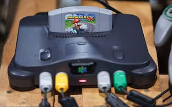 13 April 2023, Saxony, Leipzig: A Nintendo 64 game console with the game "Mario Kart" lies in a retro area of the gaming festival "CAGGTUS" at the Leipzig Fair. The "CAGGTUS" festival will take place from April 14 to 16. In addition to an entertainment and streaming area, Germany's largest lan party, according to the trade fair, will be celebrated with over 1400 participants. Visitors will be able to gamble for a whole 68 hours. Photo: Jan Woitas/dpa (Photo by Jan Woitas/picture alliance via Getty Images)