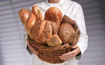 young baker, with freshly baked bread in basket