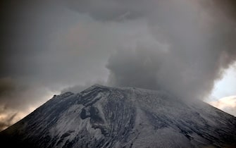 Clouds of ash and smoke are spewed from the Popocatepetl Volcano as seen from Santiago Xalitxintla, in Puebla, Mexico, on May 13, 2013. According to a report by the National Center of Prevention of Disasters (CENAPRED) the yellow alert phase three is still in force. AFP PHOTO /RONALDO SCHEMIDT        (Photo credit should read Ronaldo Schemidt/AFP via Getty Images)