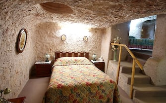 COOBER PEDY, AUSTRALIA - OCTOBER 22: The master bedroom is seen inside Faye's Underground Home on October 22, 2015 in Coober Pedy, Australia.This three bedroom dugout as locals call underground homes, was hand excavated by Faye Nayler with the help from two of her female friends using picks and shovels. It is still private residence used by the caretakers who run guided tours of the home.  (Photo by Mark Kolbe/Getty Images)