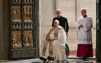 Pope Francis opens the Holy Door of St Peter's Basilica in the Vatican to mark the start of the Catholic Jubilee Year, on December 24, 2024. - Pope Francis marks Christmas Eve with a special ceremony launching Jubilee 2025, a year of Catholic celebrations set to draw more than 30 million pilgrims to Rome. Over the next 12 months, pilgrims will pass through the large and imposing bronze door, which is normally closed, by tradition benefiting from a "plenary indulgence", a type of forgiveness for their sins. (Photo by Alberto PIZZOLI / POOL / AFP)