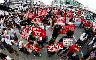 epa10765320 A photo taken with an ultra wide lens shows activists staging a protest rally along a road leading to the Congress compound in Quezon city, Metro Manila, Philippines, 24 July 2023. The protesters gathered against the State of the Nation Address (SONA) of President Ferdinand 'Bongbong' Marcos.  EPA/FRANCIS R. MALASIG