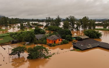 TOPSHOT - Aerial view shows a flooded area of Capela de Santana, Rio Grande do Sul state, Brazil, on May 2, 2024. . Brazilian President Luiz Inacio Lula da Silva on Thursday visited the country's south where floods and mudslides caused by torrential rains have killed 13 people, with the toll likely to rise. Authorities in Rio Grande do Sul have declared a state of emergency, as rescuers continue to search for some 21 people reported missing among the ruins of collapsed homes, bridges and roads. (Photo by CARLOS FABAL / AFP) (Photo by CARLOS FABAL/AFP via Getty Images)