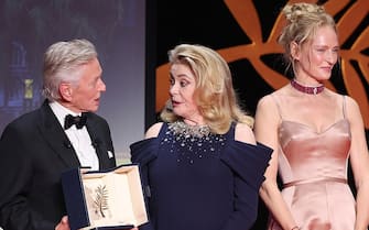 CANNES, FRANCE - MAY 16: Michael Douglas with the Honorary Palme Dâ  Or, Catherine Deneuve and Uma Thurman during the opening ceremony at the 76th annual Cannes film festival at Palais des Festivals on May 16, 2023 in Cannes, France. (Photo by Mike Coppola/Getty Images)