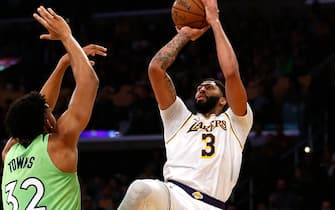 LOS ANGELES, CALIFORNIA - DECEMBER 08:  Anthony Davis #3 of the Los Angeles Lakers shoots the ball as Karl-Anthony Towns #32 of the Minnesota Timberwolves defends during the second half at Staples Center on December 08, 2019 in Los Angeles, California. NOTE TO USER: User expressly acknowledges and agrees that, by downloading and or using this photograph, User is consenting to the terms and conditions of the Getty Images License Agreement. (Photo by Katharine Lotze/Getty Images)