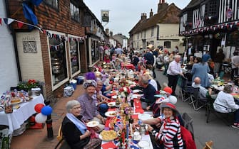 People attend a street party in Alfriston, East Sussex, on June 5, 2022 as part of Queen Elizabeth II's platinum jubilee celebrations. - Millions of people are expected to attend "Big Jubilee Lunch" picnics, as a long weekend of festivities to honour Queen Elizabeth II's historic Platinum Jubilee concludes. (Photo by Glyn KIRK / AFP) (Photo by GLYN KIRK/AFP via Getty Images)
