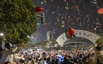 Revellers fly balloons during a New Year celebration in Wuhan, in China's central Hubei province on January 1, 2023. - China OUT (Photo by AFP) / China OUT (Photo by STR/AFP via Getty Images)