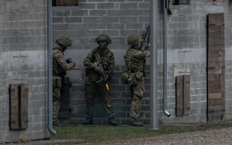 Soldiers of the NATO Response Force (NRF) are seen during a practice witnessed by the Polish Defence Minister and Britain's Defence Secretary on a military training compound next to Orzysz, North-Eastern Poland, on March 13, 2024. Britain's Secretary of Defense visits the NATO-organized Steadfast Defender 2024 military exercise in Poland. (Photo by Wojtek Radwanski / AFP)