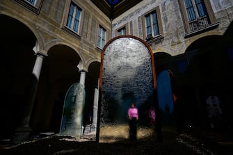 MILAN, ITALY - APRIL 16: A woman is seen through glass at the Lasvit Re/Creation installation at Palazzo Isimbardi  during the Fuorisalone in Milan, Italy on April 16, 2024. Fuorisalone is the set of events distributed in different areas of Milan on the same days when the Salone Internazionale del Mobile takes place. (Photo by Piero Cruciatti/Anadolu via Getty Images)