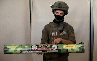 KIRYAT MALAKHI, ISRAEL - OCTOBER 20:  An Israeli soldier displays a Hamas made RPG during a presentation to the press of military equipment and ammunition that Hamas and Palestinans militants used at the time of the attack on the Israeli south border with the Gaza Strip on October 20, 2023 in Kiryat Malakhi, Israel. As Israel prepares to invade the Gaza Strip in its campaign to vanquish Hamas, the Palestinian militant group that launched a deadly attack in southern Israel on October 7th, worries are growing of a wider war with multiple fronts, including at the country's northern border with Lebanon. Countries have scrambled to evacuate their citizens from Israel, and Israel has begun relocating residents of some communities on its northern border. Meanwhile, hundreds of thousands of residents of northern Gaza have fled to the southern part of the territory, following Israel's vow to launch a ground invasion.  (Photo by Amir Levy/Getty Images)