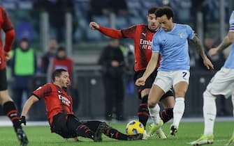 Milan's Algerian midfielder Ismael Bennacer challenges for the ball with Lazio's Brazilian forward Felipe Anderson during the Serie A football match SS Lazio vs AC Milan at Olimpico Stadium on March 01, 2024, in Rome.