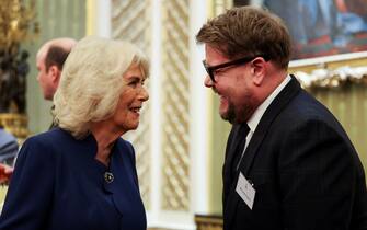 LONDON, ENGLAND - FEBRUARY 18: British Queen Camilla speaks with actor James Corden, as she attends a reception for staff, actors and supporters of the National Theatre at Buckingham Palace on February 18, 2025 in London, England. (Photo by Isabel Infantes - WPA Pool/Getty Images)
