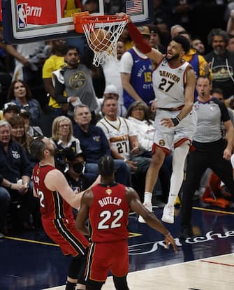 epa10687727 Denver Nuggets guard Jamal Murray of Canada (R) dunks the ball over Miami Heat forward Jimmy Butler (L) during the first half of game five of the NBA Finals between the Miami Heat and the Denver Nuggets at Ball Arena in Denver, Colorado, USA, 12 June 2023.  EPA/JOHN G. MABANGLO  SHUTTERSTOCK OUT