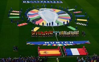 Spain's players and France's players attend the national anthems ahead of the UEFA Euro 2024 semi-final football match between Spain and France at the Munich Football Arena in Munich on July 9, 2024. (Photo by Tobias SCHWARZ / AFP)