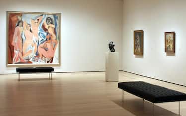 11 October 2019, US, New York: The paintings "Les Demoiselles d'Avignon" by Pablo Picasso (l) and "American People Series #20: Die" by Faith Ringgold hang in a room in the Museum of Modern Art. The MoMA is one of the most renowned art museums in the world and one of the largest tourist attractions in New York. Due to constant overcrowding it had to grow and close for four months. Now the MoMA is back - completely retreaded. Photo: Christina Horsten/dpa
