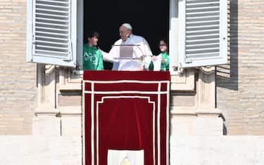 Pope Francis stands with children at the window of the apostolic palace overlooking St. Peter's square during the Angelus prayer on January 28, 2024 in The Vatican. (Photo by Alberto PIZZOLI / AFP) (Photo by ALBERTO PIZZOLI/AFP via Getty Images)