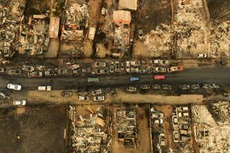 Aerial view of burned vehicles in the El Olivar commune after a forest fire that affected the hills of ViÃ±a del Mar, Chile, taken on February 3, 2024. The region of Valparaoso and ViÃ±a del Mar, in central Chile, woke up on Saturday with a partial curfew to allow the movement of evacuees and the transfer of emergency equipment in the midst of a series of unprecedented fires, authorities reported. (Photo by Javier TORRES / AFP) (Photo by JAVIER TORRES/AFP via Getty Images)