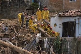 Firefighters search the rubble for missing residents following a landslide caused by heavy rain and flooding in Barra do Sahy, Sao Paulo state, Brazil, on Friday, Feb. 24, 2023. Heavy rains inundated the Sao Paulo coast during the week of Carnival, causing flooding and landslides that left dozens dead and missing. Photographer: Tuane Fernandes/Bloomberg via Getty Images