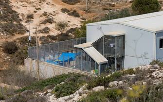A "hot spot", or detention center for migrants and refugees, bakes in the sun in the hills near the ports of Lampedusa. The tiny Italian  Mediterranean island of Lampedusa, about 50 miles by sea from Tunisia, often is the initial European contact for migrants and refugees, and has been inundated by them intermittenty. . (Photo by John Rudoff/Sipa USA)