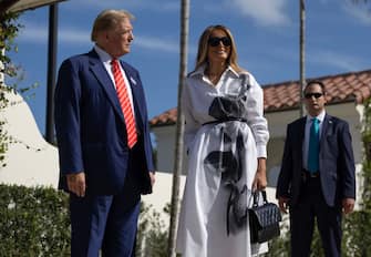 PALM BEACH, FLORIDA - MARCH 19:  Former U.S. President Donald Trump and former first lady Melania Trump stand together as they speak with the media after voting at a polling station setup in the Morton and Barbara Mandel Recreation Center on March 19, 2024, in Palm Beach, Florida.  Trump, along with other registered Republican voters, cast ballots in the Presidential Preference Primary. There wasn't a ballot or election for Democrats since the Florida Democratic Party only provided the name of Joseph R. Biden Jr. (Photo by Joe Raedle/Getty Images)
