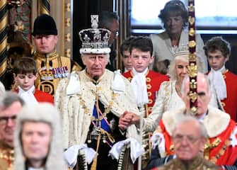 Britain's King Charles III, wearing the Imperial State Crown and the Robe of State, and Britain's Queen Camilla, wearing the George IV State Diadem, process through the Royal Gallery during the State Opening of Parliament at the Houses of Parliament, in London, on November 7, 2023. (Photo by JUSTIN TALLIS / POOL / AFP)