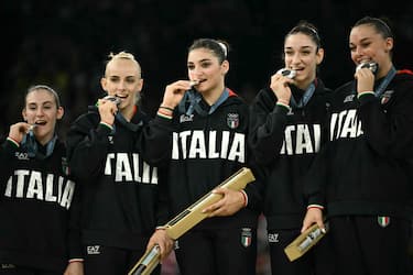 Team Italy poses with the silver medal during the podium ceremony for the artistic gymnastics women's team final during the Paris 2024 Olympic Games at the Bercy Arena in Paris, on July 30, 2024. (Photo by Lionel BONAVENTURE / AFP) (Photo by LIONEL BONAVENTURE/AFP via Getty Images)