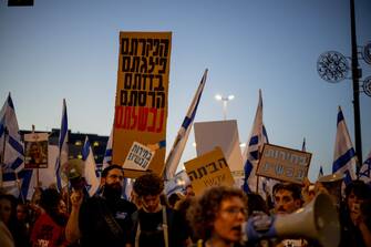 Demonstrators hold a sign that says "You have abandoned, divided, looted, destroyed, failed" in a demonstration for a kidnapping deal near the Knesset, on March 31, 2024, in Jerusalemm Israel. (Photo by Yahel Gazit / Middle East Images / Middle East Images via AFP) (Photo by YAHEL GAZIT/Middle East Images/AFP via Getty Images)