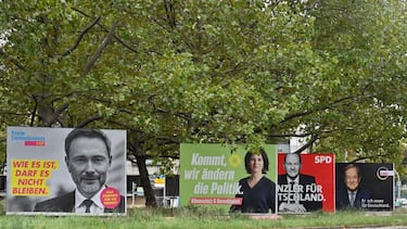 Billboards with election campaign posters showing (L-R) Free Democratic Party (FDP) leader Christian Lindner and the three chancellor candidates in the the September 26 federal election, co-leader of Germany's Greens (Die Gruenen) Annalena Baerbock, German Finance Minister and Vice-Chancellor of the Social Democratic SPD Party Olaf Scholz and Christian Democratic Union CDU leader Armin Laschet are seen in Berlin on September 25, 2021. - The campaign poster featuring Laschet has been defaced as the slogan reads "Shot dead for Germany" instead of "Determined for Germany". (Photo by John MACDOUGALL / AFP) (Photo by JOHN MACDOUGALL/AFP via Getty Images)