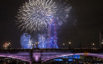 LONDON, UNITED KINGDOM - JANUARY 1: Fireworks light up the London sky over the London Eye to celebrate the new year in United Kingdom on January 1, 2023. (Photo by Rasid Necati Aslim/Anadolu Agency via Getty Images)