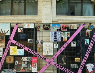 Close-up of the permanent installation "Wall of Dolls and Art" in De Ferrari Square against violence on women, Liguria, Italy