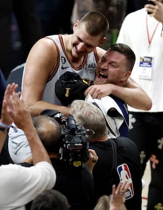 epa10687806 Denver Nuggets center Nikola Jokic of Serbia (L) is congratulated by family following the Nuggets win over the Miami Heat to win the NBA championships at Ball Arena in Denver, Colorado, USA, 12 June 2023.  EPA/JOHN G. MABANGLO  SHUTTERSTOCK OUT