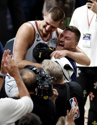 epa10687806 Denver Nuggets center Nikola Jokic of Serbia (L) is congratulated by family following the Nuggets win over the Miami Heat to win the NBA championships at Ball Arena in Denver, Colorado, USA, 12 June 2023.  EPA/JOHN G. MABANGLO  SHUTTERSTOCK OUT