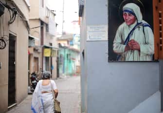 epa10160638 A person walks to attend a mass prayer at Mother House on Mother Teresa's 25th death anniversary, in Kolkata, India, 05 September 2022. Mother Teresa, who died on 05 September 1997, at the age of 87, was popularly known as the 'Saint of the Gutter' for her extraordinary love and dedication to poor, homeless and diseased people. She won the Nobel Peace Prize in 1979. Mother Teresa was canonized as a saint by Pope Francis in 2016.  EPA/PIYAL ADHIKARY