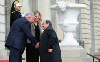 France's former President Francois Hollande (R) is welcomed by President of the French National Assembly Yael Braun-Pivet (C) and French Senate President Gerard Larcher (L) at Hotel de Lassay, residency of the President of the National Assembly in Paris ahead of a march against anti-Semitism in Paris, on November 12, 2023. Tens of thousands are expected to march Sunday in Paris against anti-Semitism amid bickering by political parties over who should take part and a surge in anti-Semitic incidents across France. Tensions have been rising in the French capital, home to large Jewish and Muslim communities, in the wake of the October 7 attack by Palestinian militant group Hamas on Israel, followed by a month of Israeli bombardment of the Gaza Strip. France has recorded nearly 12,250 anti-Semitic acts since the attack. National Assembly speaker Yael Braun-Pivet and Gerard Larcher, the Senate speaker, called on November 7 for a "general mobilisation" at the march against the upsurge in anti-Semitism. (Photo by Thomas SAMSON / AFP) (Photo by THOMAS SAMSON/AFP via Getty Images)