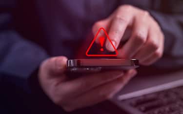 People with warning notification and spam message icon on mobile phone, Spam link on smartphone, Virus on smartphone, Alert warning scam, Hacker
