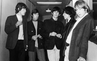 UNITED KINGDOM - AUGUST 18:  Group photo of the ROLLING STONES August 18, 1964 at the London airport. From left to right, the singer Mick JAGGER, the drummer Charlie WATTS, the guitarist Keith RICHARD, the bass player Bill WYMAN and the guitarist and composer Brian JONES. They left for Guernsey island for a concert as a part of their Channel Islands Tour. The group at that time had released only one album: "THE ROLLING STONES" but the success of the music "IT'S ALL OVER NOW" which came out in 1964 and was later integrated into the album "12*5" propelled them into the major summer festivals and onto their first stages.  (Photo by Keystone-France/Gamma-Keystone via Getty Images)