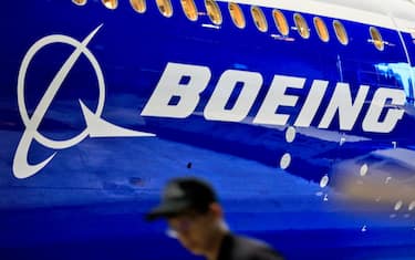 epa08967893 (FILE) - A file photo dated 14 June 2016 showing a man walking past a logo of US aircraft manufacturing company Boeing at Taoyuan airport, in Taoyuan, Taiwan (reissued 26 January 2021). Boeing is due to release its 4th quarter 2020 results on 27 January 2021.  EPA/RITCHIE B. TONGO *** Local Caption *** 56030419