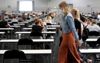 epa08507987 Over 700 students of the TU Dortmund University write their exams in German for Foreigners in the Westfalenhalle in Dortmund, Germany, 25 June 2020. In order to slow down the ongoing pandemic of COVID-19 disease caused by the SARS-CoV-2 coronavirus, about 7500 students will write their exams in the exhibition hall in the upcoming days, in compliance with the hygiene concept.  EPA/FRIEDEMANN VOGEL