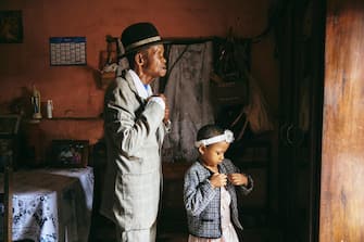 Dada Paul Rakotazandriny (91), who is living with dementia, and his granddaughter, Odliatemix Rafaraniriana (5), get ready for church on Sunday morning at his home in Antananarivo, Madagascar. 12 March 2023