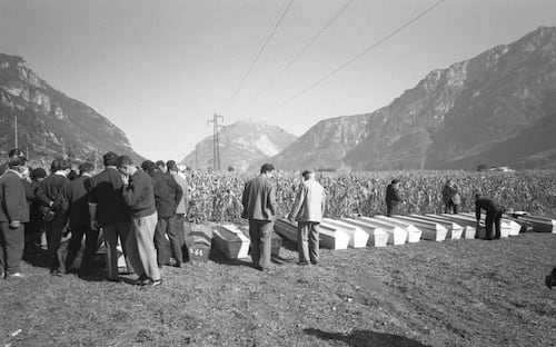 Survivors pay their last respects beside a line of coffins, Longarone, near the Vajont Dam in the Piave Valley, Italy, early October, 1963. On October 9, a landslide in the dam basin caused a wave more than 800 feet high to overtop the dam and flood the valley below--five villages were completely destroyed, more than 2000 people were killed, and thousands more were left homeless and displaced. (Photo by Archivio Cameraphoto Epoche/Getty Images)