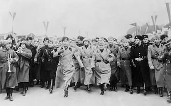 (Original Caption) Setting an example for his admiring staff, Premiere Benito Mussolini of Italy is shown here doing the goose step, Germany's ceremonial military march, which IL Duce now has proclaimed "The Roman Step." Mussolini has ordered his Fascist legions to adopt the step in preparation for the visit of realm leader Hitler of Germany to Rome in the Spring.