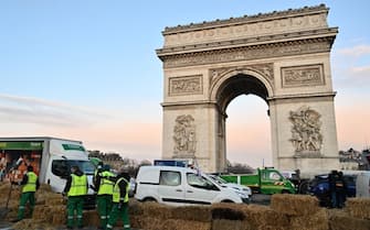 PARIS, FRANCE - MARCH 01: City workers clear the road in front of the Arc de Triomphe on the Champs-Elysees after a protest by the French farmers' union in Paris, France on March 1, 2024. (Photo by Mustafa Yalçn/Anadolu via Getty Images)