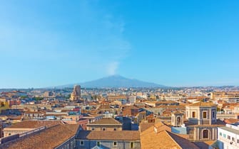 Panorama of the old town of Catania with Mount Etna volcano, Sicily, Italy
