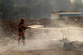 epa10762699 A firefighter tries to put out a wildfire in Kiotari village, on Rhodes island, Greece, 22 July 2023. Although the Fire Department had managed to put out several rekindled blazes on the island over the last few days, the wildfire near the village of Laerma in the island's north keeps expanding and moving eastwards to the Gadoura dam, while residents in the villages of Lardos and Pilonas were told to evacuated their homes on the day, via the emergency number 112. Some 173 firefighters with 35 fire engines and 10 ground teams are battling the blaze, assisted by 3 water bombers and 2 helicopters. Another 31 firefighters with 4 fire engines and 3 ground teams were also expected to arrive from Slovakia. Local authority water tanks are also helping out.  EPA/DAMIANIDIS LEFTERIS