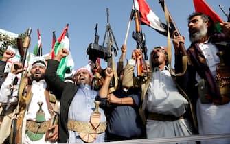 SANA'A, YEMEN - OCTOBER 18: Yemen's Houthi supporters hold banners and flags as they chant and protest against Israel on its aerial offensive on the Gaza Strip on October 18, 2023 in Sana'a, Yemen. (Photo by Mohammed Hamoud/Getty Images)